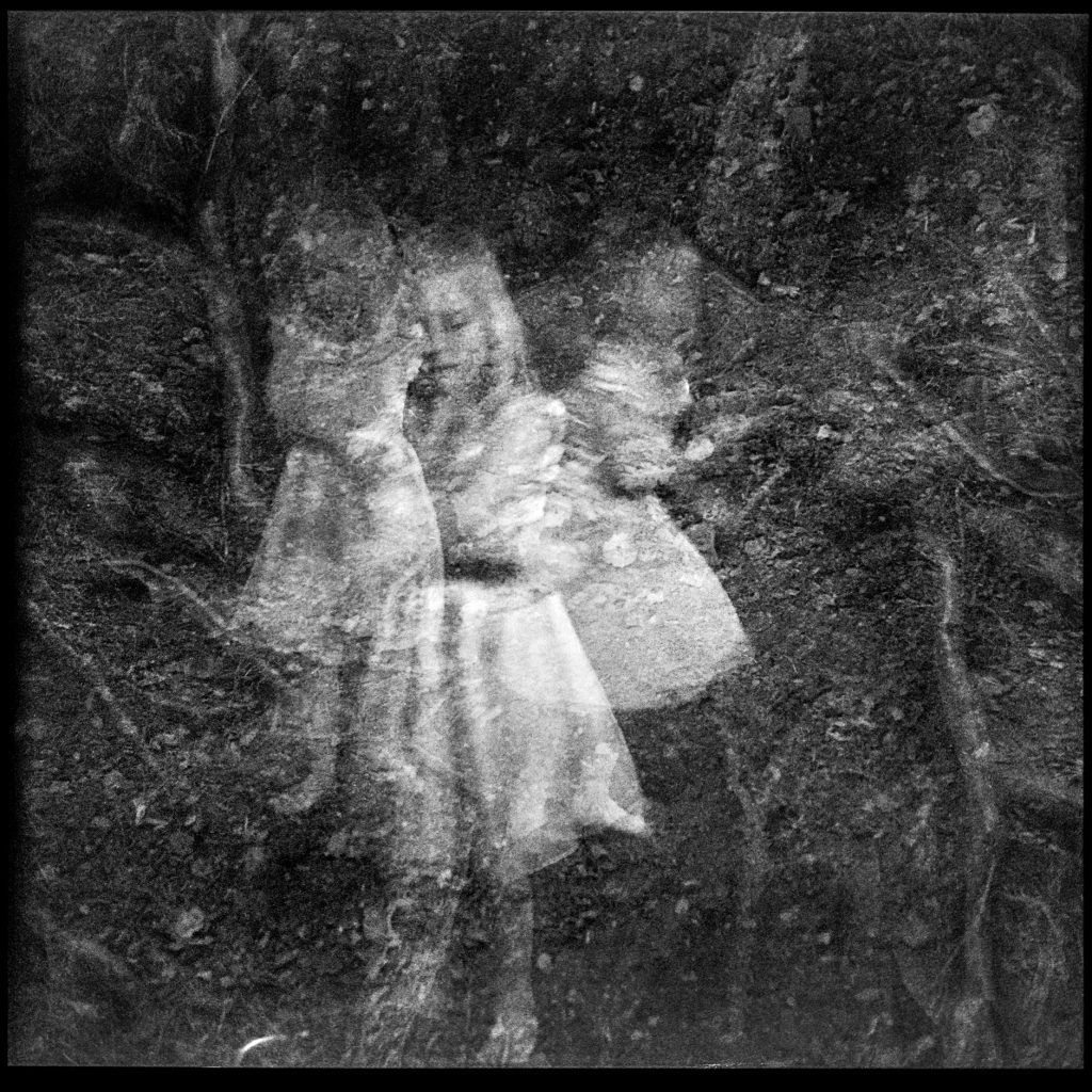 Black and white multi exposure photo of child and Forrest