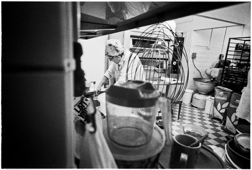 Black and white documentary picture of a baker in the store