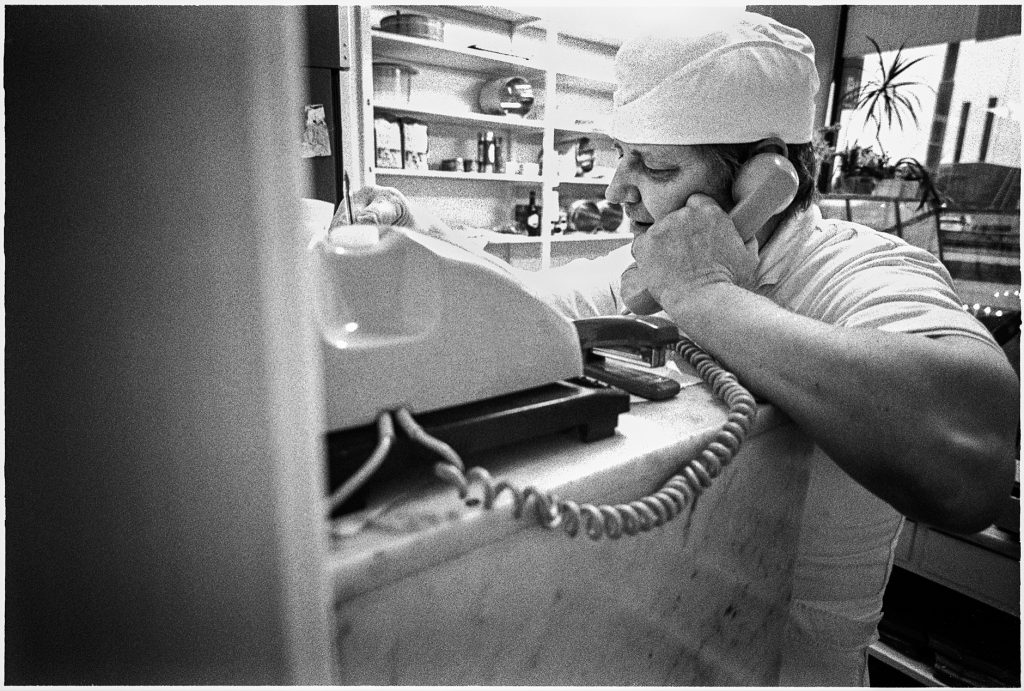 Black and white documentary picture of a baker in the store