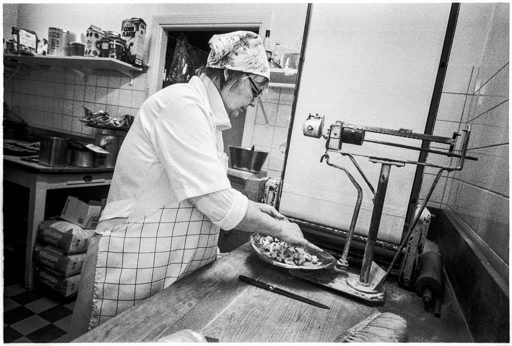 Black and white documentary picture of a baker in the store