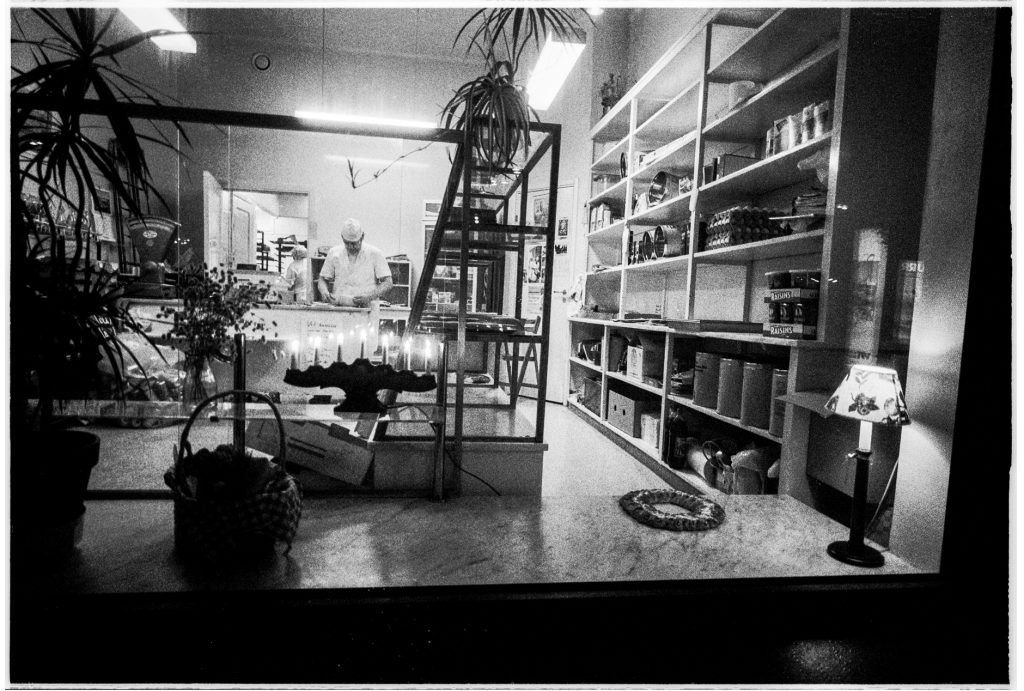 Black and white documentary picture of a baker in the store