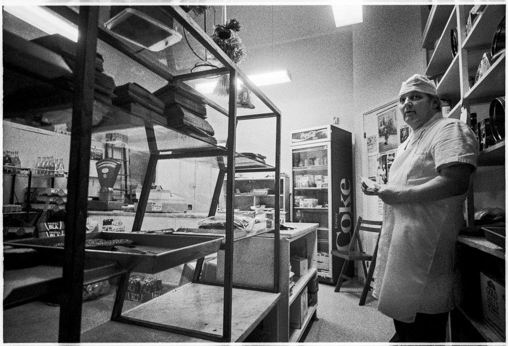 Black and white documentary picture of a baker in the store