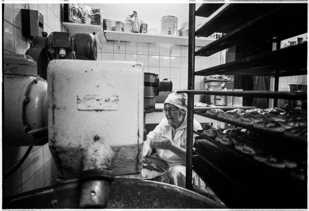 Black and white documentary picture of a baker in the store