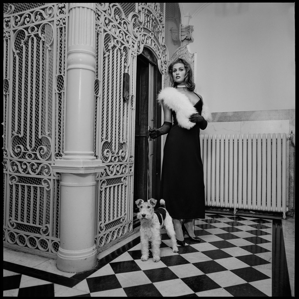 Old fashion black and white image of a lady with a dog